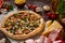 Pizza still life. Freshly baked pizza and its components arranged on wooden background.