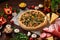 Pizza still life. Freshly baked pizza and its components arranged on wooden background.