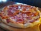 Pizza time ! pepperoni cheese pizza a succulent tasty meal on a wooden rustic board