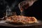 Pizza with tomato, mozzarella and olives on black background, In a close-up view, the hands of a chef skillfully assemble a