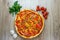 Pizza with tomato sauce, salami, green olives, corn, cheese and red bell pepper top view