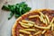 Pizza with tomato sauce, sausage and french fries detail