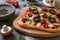 Pizza with tomatoes, mushrooms, and parmesan cheese in an irregular shape