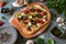 Pizza with tomatoes, mushrooms, and parmesan cheese in an irregular shape
