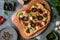 Pizza with tomatoes, mushrooms, and parmesan cheese in an irregular shape