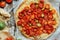 Pizza with tomatoes, shallot and fresh herbs. Cherry Tomato Wood