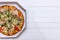 Pizza with tomatoes. Top view on white wooden table with copy space for your text