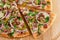 Pizza top view cutted on 8 pieces and one pushed forward. Advert for pizzeria caffee and restaurant. Food delivery at