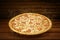 Pizza on wooden background. Flying hot pizza margarita closeup with mozzarella cheese, tomato and  steam smoke