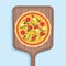 Pizza on a wooden shovel for a stove