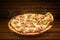 Pizza on wooden table. Flying hot pizza pepperoni closeup with mozzarella cheese and  steam smoke