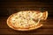Pizza on wooden table. Flying hot pizza seafood closeup with mozzarella cheese and  steam smoke