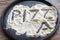 Pizza word written on the flour