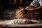 Pizzaiolo sprinkling flour onto a wooden surface and stretching pizza dough with both hands, illustrating the handmade and