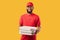 Pizzeria Courier Man Delivering Pizza Standing On Yellow Studio Background