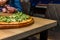 Pizzeria - pizza on the table in the foreground and the hall blurred in the background