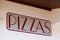 Pizzeria pizzas sign words painted on a restaurant shop wall of italian pizza food