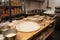 pizzeria prep station, with rolling pins and trays of fresh dough ready to be made into delicious pies