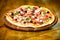 Pizzeria restaurant. Delicious hot pizza on wooden board plate. Food delivery service. Pizza served with dill. Pizza