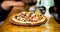Pizzeria restaurant. Italian pizza concept. Delicious hot pizza on wooden board plate. Food delivery service. Pizza