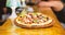 Pizzeria restaurant. Italian pizza concept. Delicious hot pizza on wooden board plate. Food delivery service. Pizza