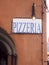 Pizzeria restaurant sign on old building in Vernazza Cinque Terre Italy