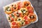 Pizzette Italian mini pizzas or pizza bites close-up on parchment. Horizontal top view
