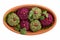 Pkhali or Phali clay bowl ketsi isolated on white. Set of multicolored vegan balls from beets, spinach, ground nuts and herb.