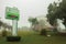 Placard on a garden and church in a foggy day