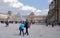 : Place Carrousel, Louvre. Tourists walk and take pictures.