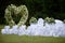 Place decorated for the wedding ceremony with heart arch from white flowers. Outdoors setup