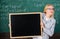 Place for school news. School schedule and extra classes. Teacher woman hold blackboard blank advertisement copy space