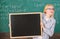 Place for school news. School schedule and extra classes. Teacher woman hold blackboard blank advertisement copy space