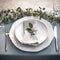 Place setting for dinner. Elegant table decorated with eucalyptus branches.
