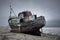 Place of a shipwreck, the abandoned former fishing trawler boat on the shore. Scotland.