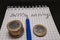 place for text, notebook, graph with pen and euro coins. Close-up of a pen and euro coins on top of a financial graph