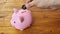 Place a yen coin into a pink piggy bank on a wooden table