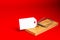 Place for your text, marketing. White paper tag in a wooden mousetrap on a red background.