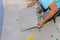 Placing ceramic tiles on glue-smeared floors using tile adhesive
