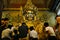 Placing gold leaf on gold statue of Buddha in Mahamuni temple in Mandalay.
