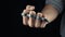 Placing knuckle-duster on the hand male fist with brass knuckles
