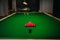 Placing snooker balls on a green billiard table