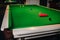 Placing snooker balls on a green billiard table