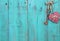 Plaid heart and bronze skeleton key hanging on antique teal blue wood door