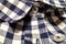 Plaid shirt close up with collar and buttons. Cotton material, textiles fabric. Everyday wear for men and woman