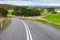 Plain asphalt road curve through Adelaide Hills farmlands