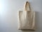 A plain Blank tote canvas bag isolated on a gray backdrop