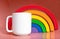 Plain blank white 11oz cup in front of a wooden toy rainbow