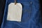 Plain clothing tag on jeans background