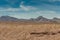 Plain desert floor in front of mountains, Nelson Nevada USA